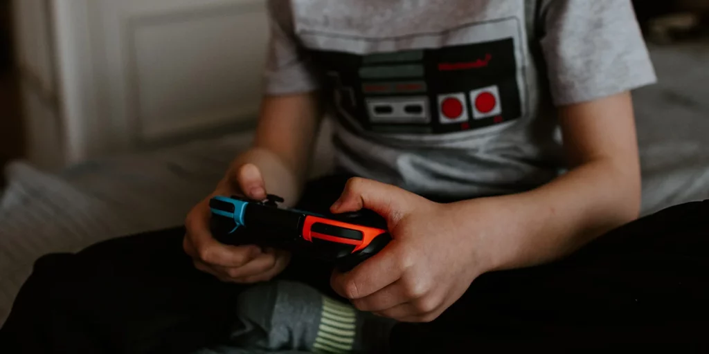 Menino a jogar consola de videojogos